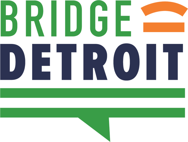 Logo of Bridge Detroit featuring the words 'BRIDGE' in green and 'DETROIT' in dark blue. A simple orange arc above the 'I' in 'BRIDGE' and two green horizontal lines beneath the text.