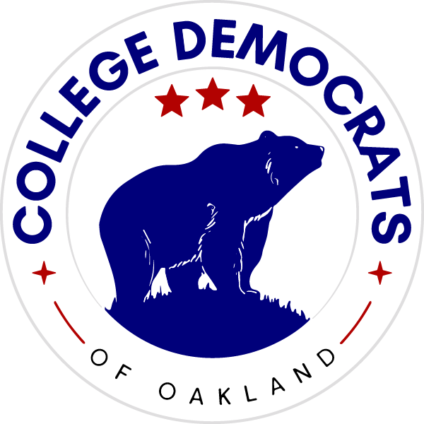A circular logo featuring a blue silhouette of a bear on a dark blue background. The top text reads "COLLEGE DEMOCRATS" in bold, white letters, with three red stars above it. At the bottom, the text "OF OAKLAND" is displayed in smaller black letters.